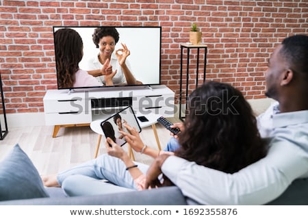 Stock photo: Family Watching Tv Through Tablet Streaming Television