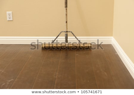 Сток-фото: Push Broom On A Newly Installed Laminate Floor And Baseboard