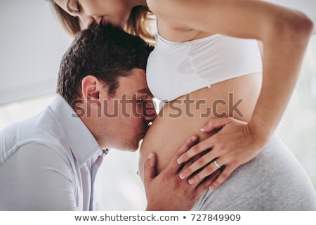 Stok fotoğraf: Happy Young Husband And His Pregnant Wife