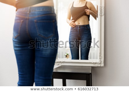 ストックフォト: Young Woman Checking Her Belly