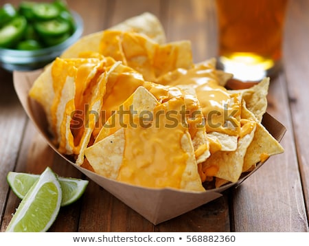 Foto stock: A Plate Of Delicious Tortilla Nachos With Melted Cheese Sauce Grilled Chicken