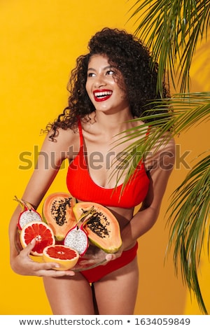 Foto stock: Optimistic Young African Woman Holding Exotic Fruits