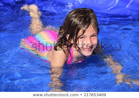 Six Year Old Girl Bathing In Pool Imagine de stoc © mangostock