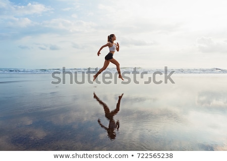 Foto stock: Happy Sporty Woman Jumping At Caribbean Beach