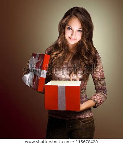 ストックフォト: Smiling Brunette Woman In Sweater Holding Gift Box