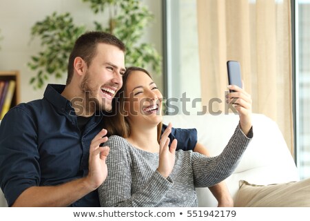 Stok fotoğraf: Happy Couple Taking Selfie By Smartphone At Home
