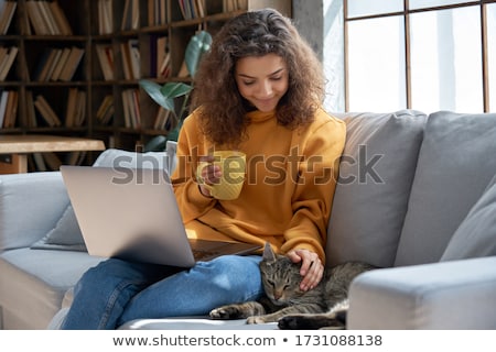 Stock photo: Young Woman Is Drinking Coffee And Stroking The Cat