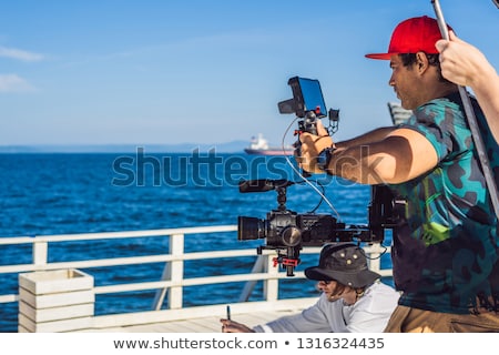 Stockfoto: Professional Steadicam Operator Uses A 3 Axis Camera Stabilizer System On A Commercial Production Se