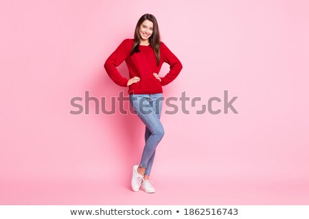 Stok fotoğraf: Smiling Woman In Pullover With Hands On Hips