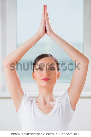 Foto stock: Portrait Of A Young Beauty Performing The Yoga Sitting Tree Posi