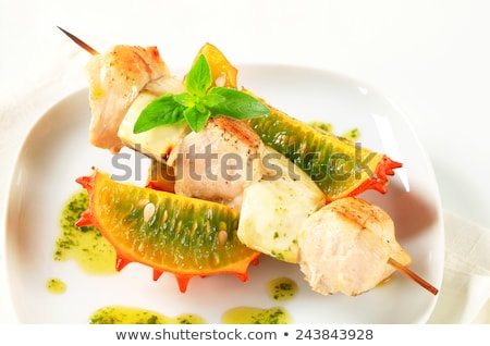Сток-фото: Chicken And Aubergine Skewer With Pesto And Horned Melon
