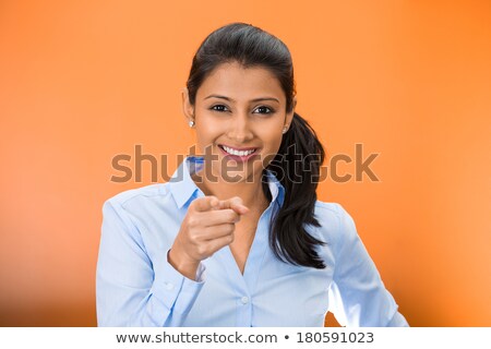 Foto d'archivio: Portrait Of A Smiling Silly Girl Pointing Finger