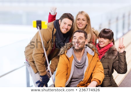 Foto stock: Teenage Girls Taking Picture By Selfie Stick