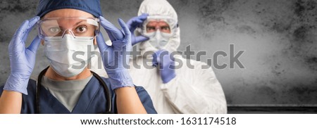 Stock photo: Female And Male Doctors Or Nurses Wearing Scrubs And Protective