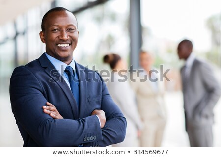 Foto stock: Business Executive Male Standing With Arms Folded