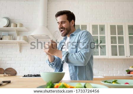 Stockfoto: Young Man Singing At Home Karaoke