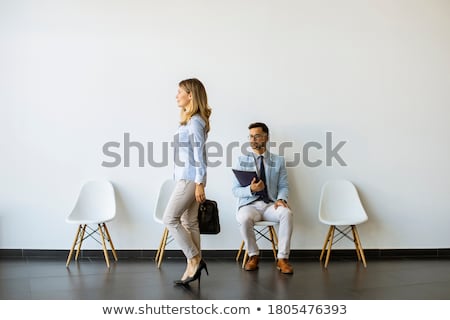 Сток-фото: Young Man Sitting In The Waiting Room With A Folder In Hand And