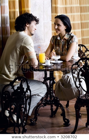 Stockfoto: Amazing Young Loving Couple Sitting In Cafe