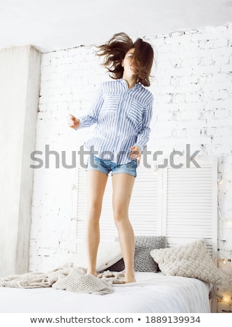 Stok fotoğraf: Young Pretty Brunette Woman In Her Bedroom Sitting At Window Happy Smiling Lifestyle People Concept