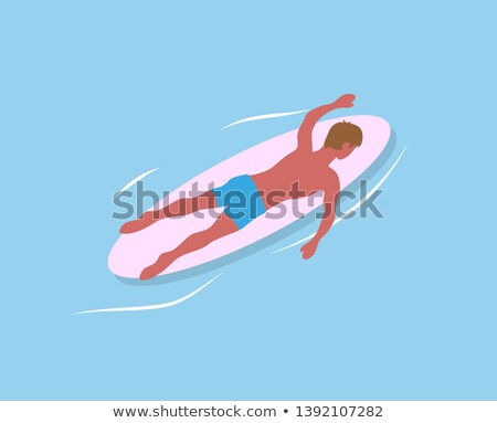 Stock photo: Boy Relaxing On A Surfboard In The Pool