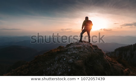 Foto stock: Man Standing On Top Of Cliff