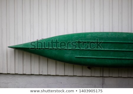 ストックフォト: Plastic Canoes Hanging On The Wall