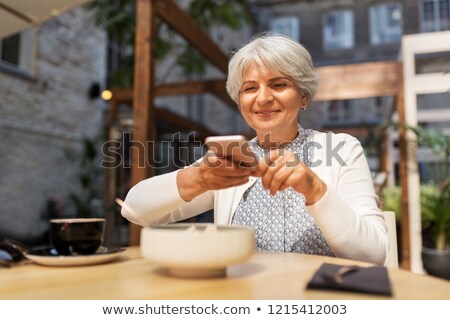 Stockfoto: Senior Woman Photographing Food At Street Cafe