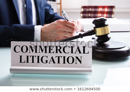 Stok fotoğraf: Commercial Litigation Text On Nameplate Near Judge Working