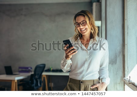 Foto d'archivio: Caucasian Business Woman Holding A Mobile Phone