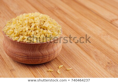 ストックフォト: Bulgur In Wooden Bowl On Brown Bamboo Board Close Up Rustic Style Healthy Dietary Groats Backgro