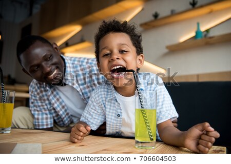 [[stock_photo]]: Young Kid Drinking At Cafe