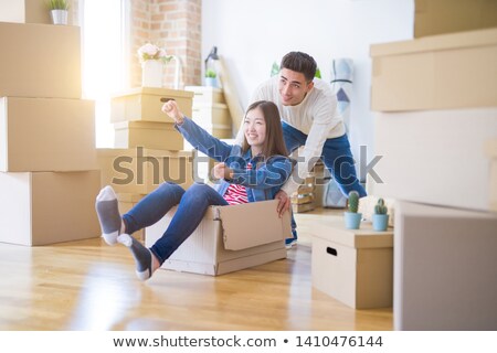 Foto stock: Happy Asian Couple Playing With Cardboard Boxes