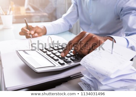 Foto d'archivio: Businessman Calculating Invoice In Office