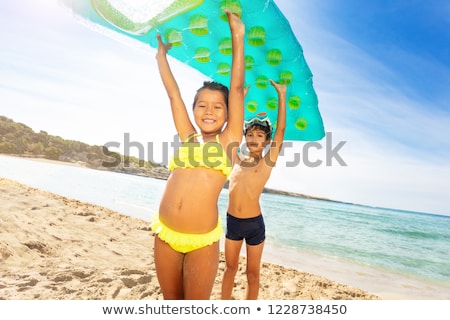 Foto stock: Children Kid Girl Playing In Beach Floating Lounge