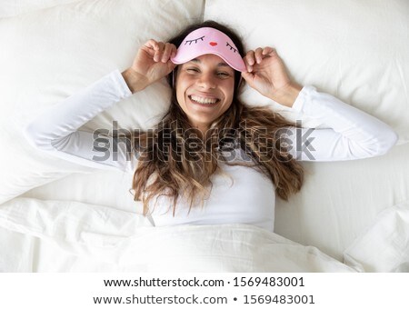 Foto stock: Portrait Of A Beautiful Young Woman Laying On The Pillow