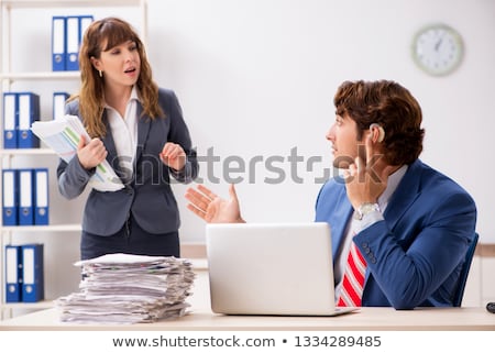 Stockfoto: Deaf Employee Using Hearing Aid In Office