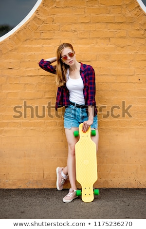 Stockfoto: Teenage Girls With Short Skateboards In City
