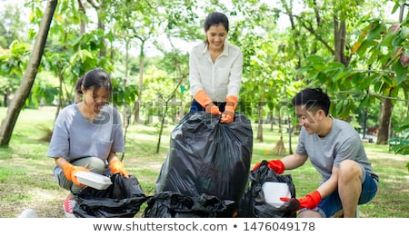 Stok fotoğraf: Man Collecting Garbage Outdoors