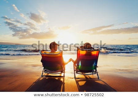 ストックフォト: Silhouettes Of People On Beach At Sunset