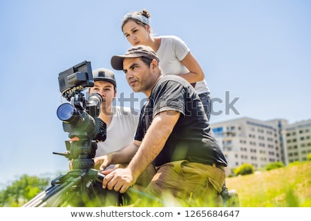 Foto stock: Camera Operator Director And Dp Discuss The Process Of A Commercial Video Shoot