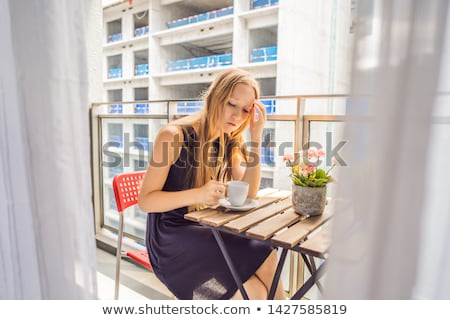 Stock fotó: Young Woman On The Balcony Annoyed By The Building Works Outside Noise Concept Air Pollution From