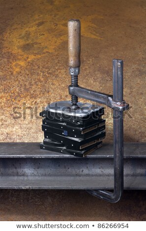 Foto stock: Clamp Pressing On Stack Of Hard Drives