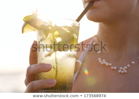 Woman Drinking A Glass Of Water By The Seaside Stock fotó © d13