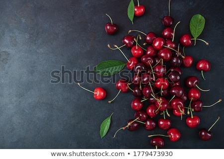 Stock fotó: Heap Of Cherries And Leaf