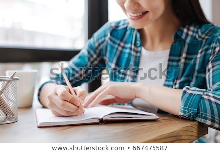 Stock fotó: Woman Writing On Notebook