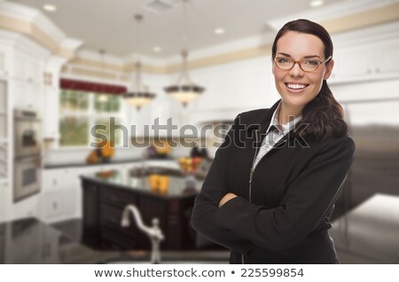 Stock fotó: Mixed Race Young Woman Standing In Beautiful Custom Kitchen