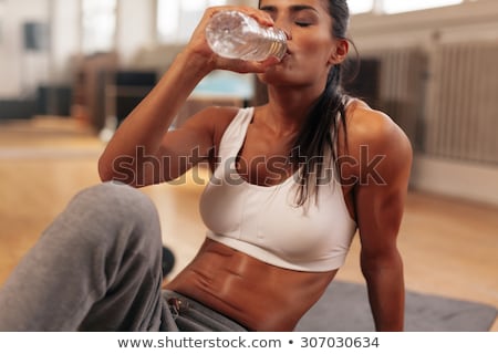 Сток-фото: Young Fit Woman Drinking Water At Gym