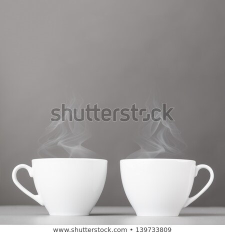 Foto d'archivio: Two Cups Of Tea On The Glass Desk