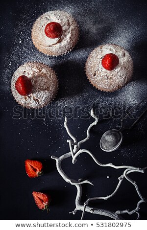 [[stock_photo]]: Christmas Cupcakes With Strawberries And Powdered Sugar On Black Background Top View