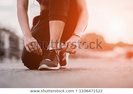 Foto stock: Running Shoes - Woman Tying Shoe Laces